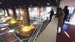 People considering investing in whiskey casks tour a partner distillery