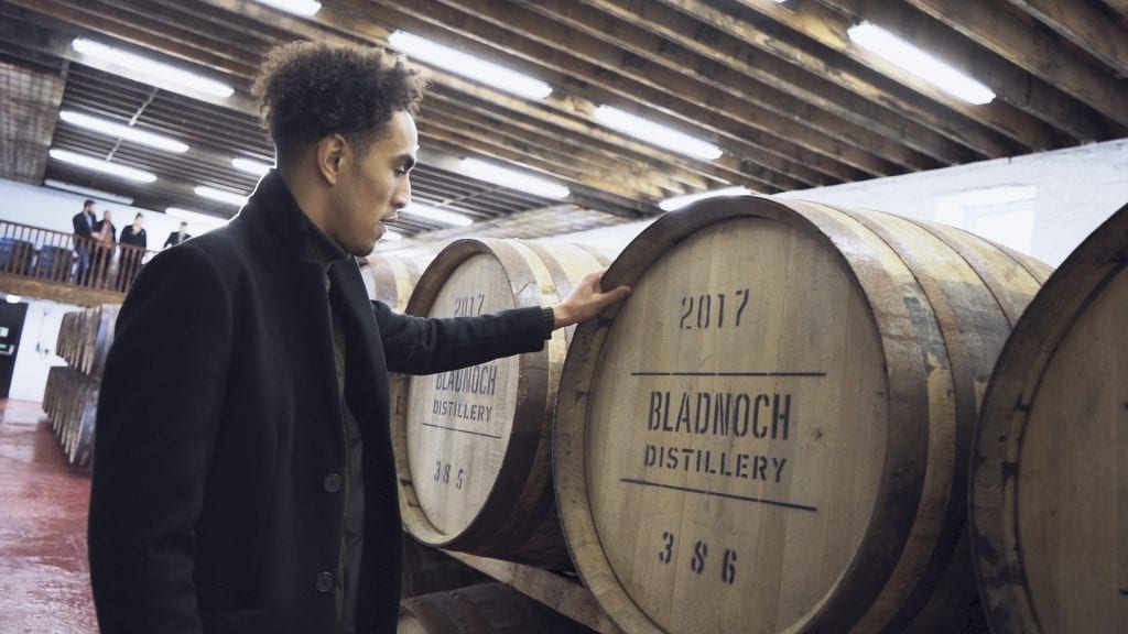 person considering investing in whiskey casks during a distillery tour